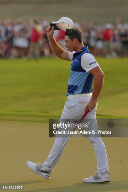 Viktor Hovland of Norway waves to the crowd after winning the TOUR Championship on the green of hole at East Lake Golf Club on August 27, 2023 in...
