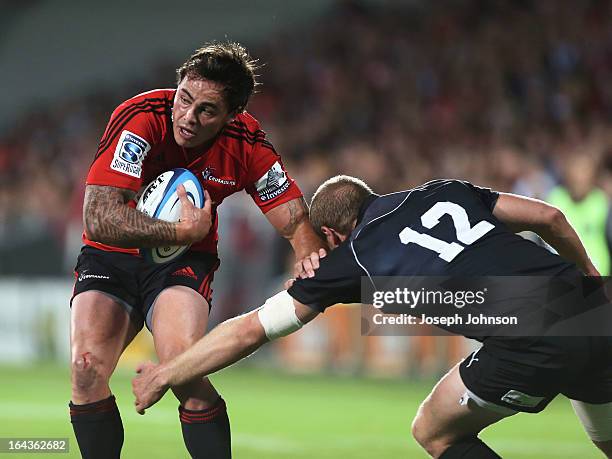 Zac Guildford of the Crusaders runs into the tackle of Hadleigh Parkes of the Kings during the round six Super Rugby match between the Crusaders and...