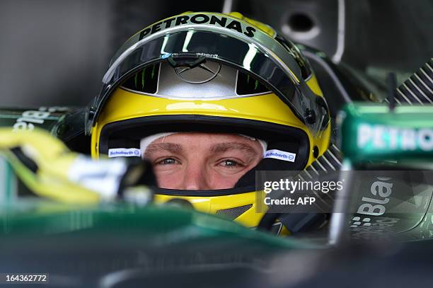 Mercedes driver Nico Rosberg of Germany looks out from the garage during the third practice session of the Formula One Malaysian Grand Prix in Sepang...