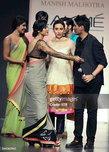 Indian Bollywood film actresses Priyanka Chopra, Kajol Devgan and Karishma Kapoor showcase creations by designer Manish Malhotra during a fashion...