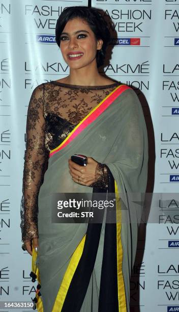 Indian Bollywood film actress Kajol Devgan poses in a creation by designer Manish Malhotra on the first day of the Lakme Fashion Week Summer/Resort...