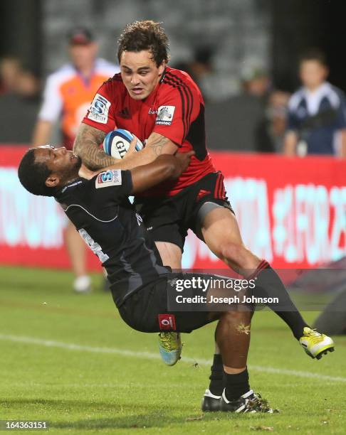 Zac Guildford of the Crusaders with the ball in the tackle of Sergeal Petersen of the Kings during the round six Super Rugby match between the...