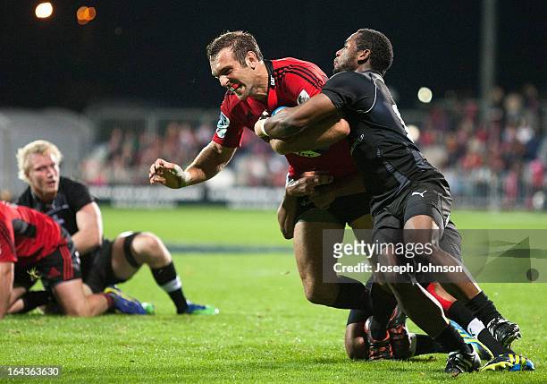 Adam Whitelock of the Crusaders scoring a try in the tackle of Sergeal Petersen of the Kings during the round six Super Rugby match between the...