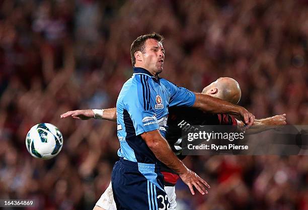 Lucas Neill of Sydney FC competes for the ball against Dino Kresinger of the Wanderers during the round twenty six A-League match between the Western...