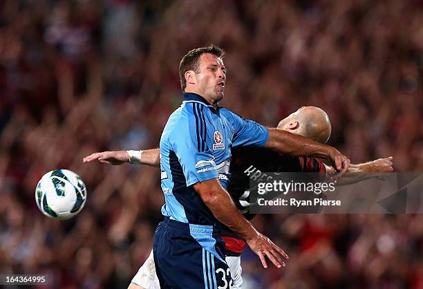 Lucas Neill of Sydney FC competes for the ball against Dino Kresinger of the Wanderers during the round twenty six A-League match between the Western...