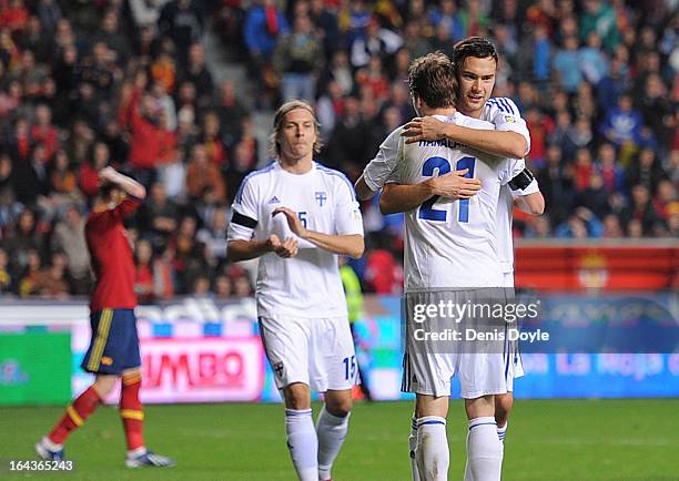 Kasper Hamalainen of Finland celebrates with a teammate after Finland drew 1-1 against Spain in the FIFA 2014 World Cup Qualifier between Spain and...