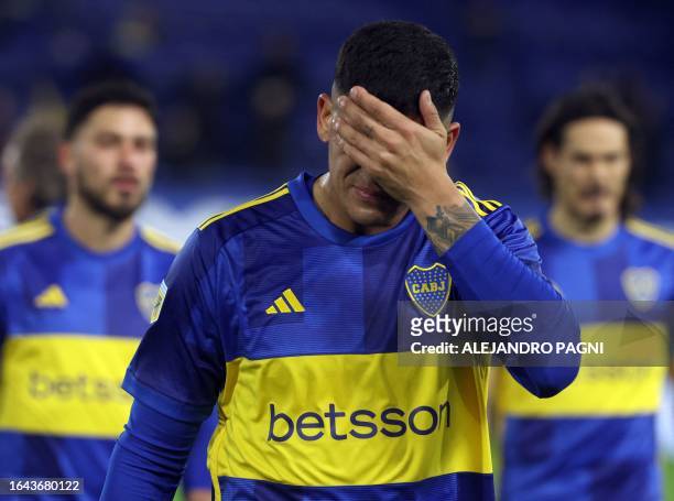 Boca Juniors' defender Marcos Rojo gestures while leaving the fiel after losing against Tigre during the Professional League Cup football match at La...