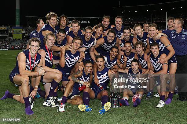 The Dockers pose with the Western Derby trophy after winning the round one AFL match between the Fremantle Dockers and the West Coast Eagles at...
