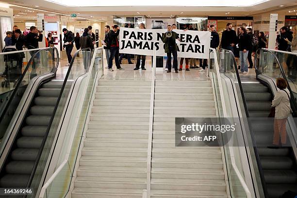 Protesters hold a banner reading "Paris will never be Qatar" during a demonstration by the French far-right organization Bloc Identitaire to protest...