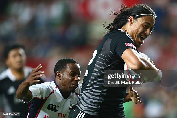 Ben Lam of New Zealand breaks away to score a try during the match between New Zealand and the USA on day two of the 2013 Hong Kong Sevens at Hong...