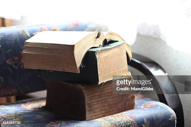 old thick book on a old chair - dicht stock-fotos und bilder