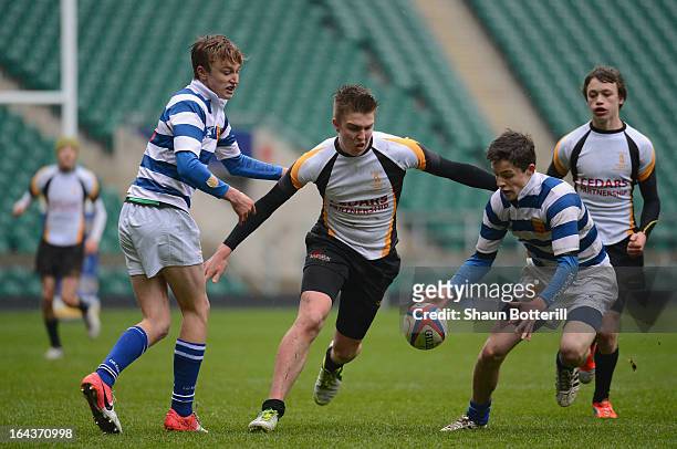 Henry Longhurst of QEDS Wakfield and William Stride and Jack Ashford of Warwick School challenge for the ball during the Daily Mail RBS Schools' Day...