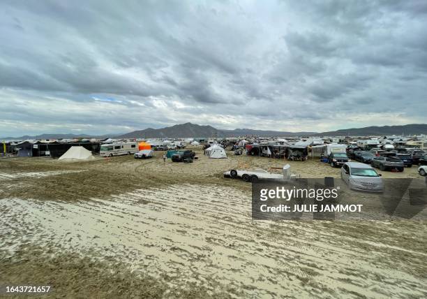 Camps are set on a muddy desert plain on September 2 after heavy rains turned the annual Burning Man festival site in Nevada's Black Rock desert into...