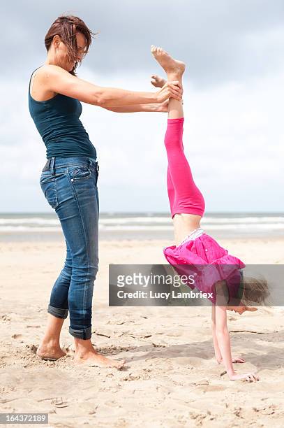 hand stand - girl in dress doing handstand fotografías e imágenes de stock