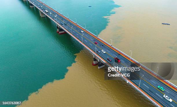 Aerial view of the green-yellow Han River after a heavy rainfall on August 27, 2023 in Xiangyang, Hubei Province of China. Heavy rainfall washes sand...