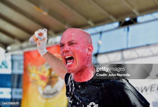 Craig Healy douses himself in water after winning the Xxxhot Chicken Wing Eating Contest during Wingfest on September 3, 2023 at Highmark Stadium,...
