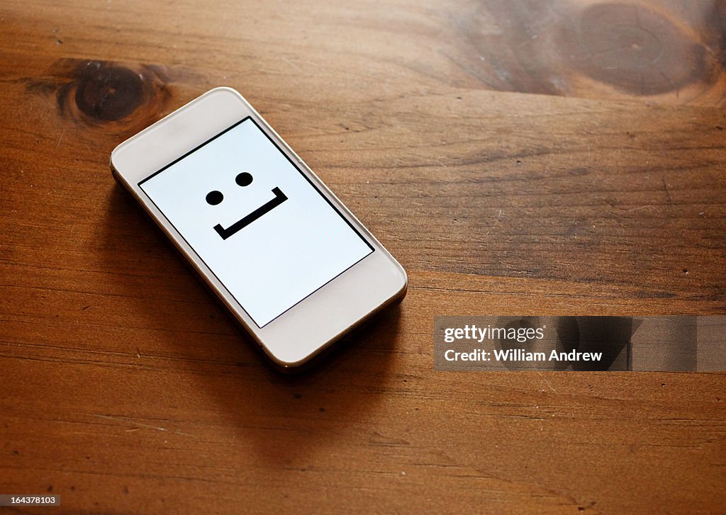 Smartphone with emoticon smile face