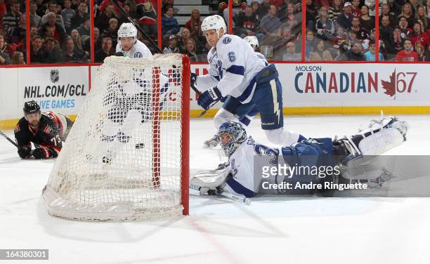 Victor Hedman, Sami Salo and Mathieu Garon of the Tampa Bay Lightning watch the puck go into the net for a first period goal by Guillaume Latendresse...
