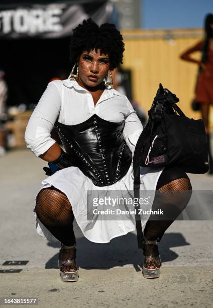 Ebrisha is seen wearing a Fashion Nova white dress and a black corset during the 2023 Afropunk festival at Greenpoint Terminal on August 27, 2023 in...