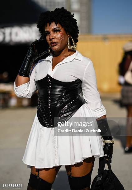 Ebrisha is seen wearing a Fashion Nova white dress and a black corset during the 2023 Afropunk festival at Greenpoint Terminal on August 27, 2023 in...