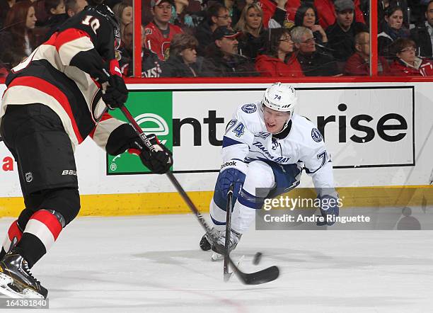 Mike Lundin of the Ottawa Senators makes a pass as Ondrej Palat of the Tampa Bay Lightning tries to deflect the puck on March 23, 2013 at Scotiabank...