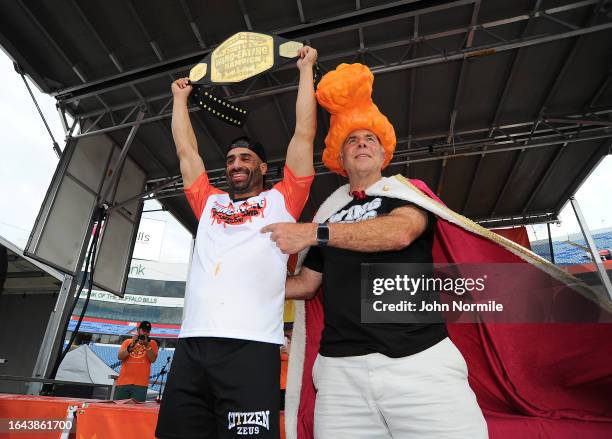 James Webb is crowned champion by "Wing King" Drew Cerza after downing 277 wings in 12 minutes to win the National Chicken Wing Eating Contest on...