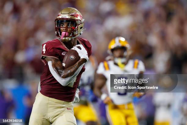 Florida State Seminoles wide receiver Keon Coleman runs downfield with a 40-yard touchdown reception in the first quarter of a college football game...