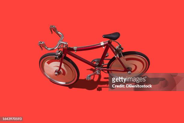red racing bicycle on red background. concept of cycling, sport, vuelta españa, tour to spain, training, winning, red maillot, losing and effort. - training wheels fotografías e imágenes de stock
