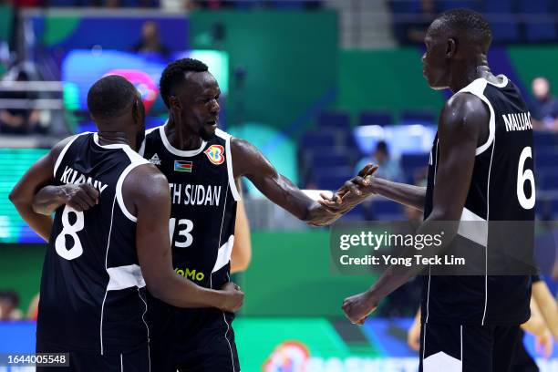 Kuany Ngor Kuany, Majok Deng and Khaman Madit Maluach of South Sudan celebrate after the FIBA Basketball World Cup Group B victory over China at...