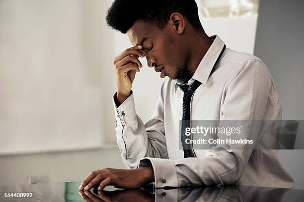 black male under stress - man headache stock pictures, royalty-free photos & images