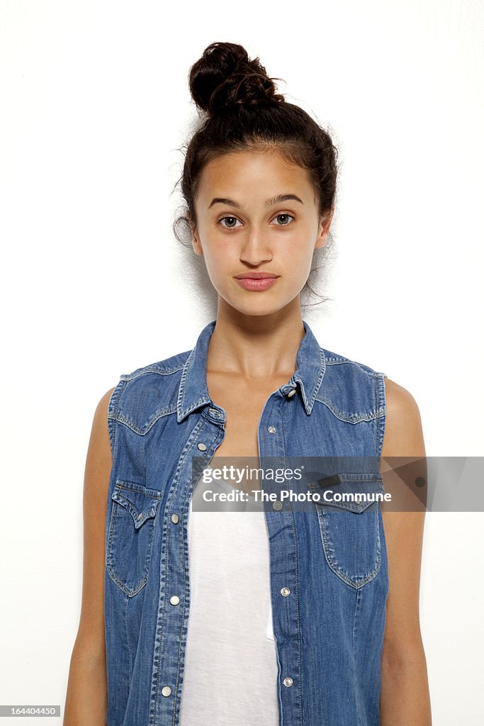 Teenage model in studio posing in denim for camera