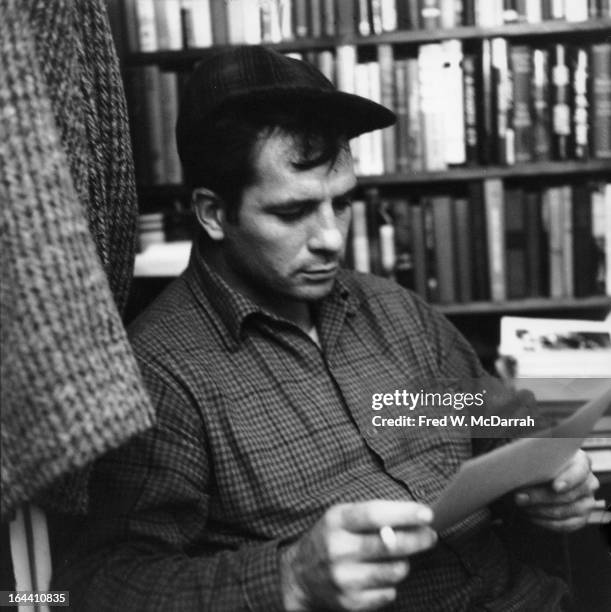 American author and poet Jack Kerouac contemplates a poem at the apartment of photographer McDarrah and his soon-to-be wife, Gloria, New York, New...