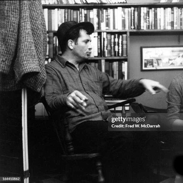 American author and poet Jack Kerouac contemplates a poem at the apartment of photographer McDarrah and his soon-to-be wife, Gloria , New York, New...