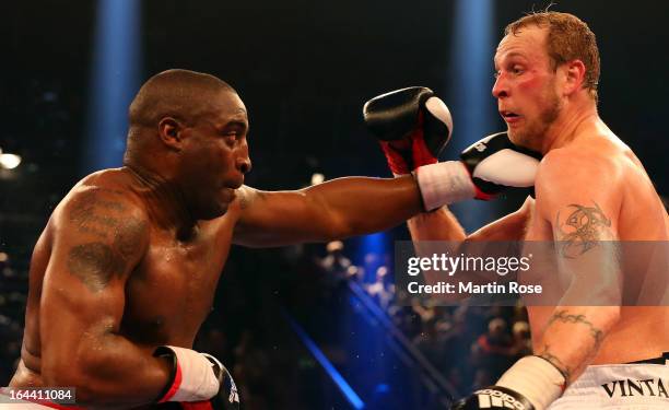 Michael Sprott of England and Robert Helenius of Finland exchange punches during the Heavyweight fight at Getec Arena on March 23, 2013 in Magdeburg,...