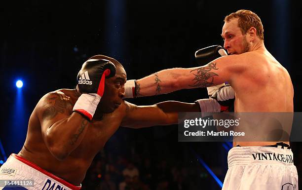 Michael Sprott of England and Robert Helenius of Finland exchange punches during the Heavyweight fight at Getec Arena on March 23, 2013 in Magdeburg,...