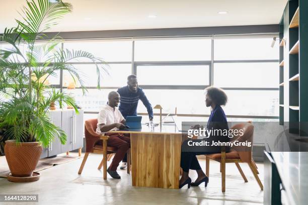 african business team collaborating in coworking environment - kenya business stock pictures, royalty-free photos & images