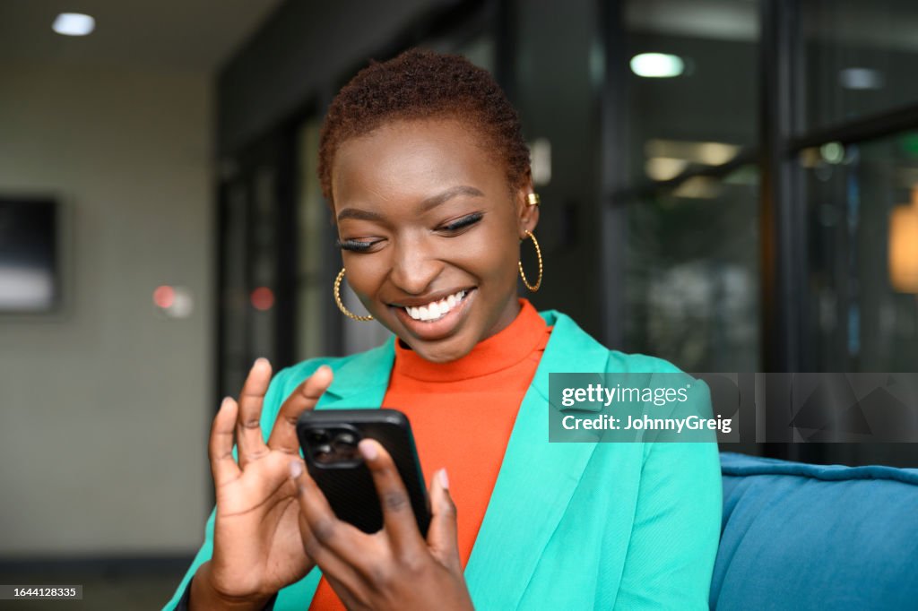 Cheerful young business professional using smart phone