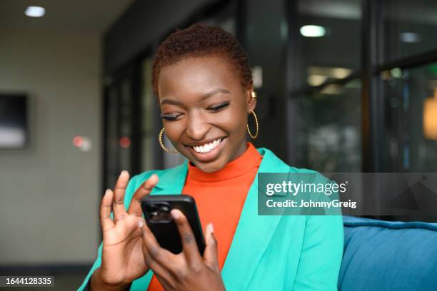 cheerful young business professional using smart phone - nairobi people stock pictures, royalty-free photos & images