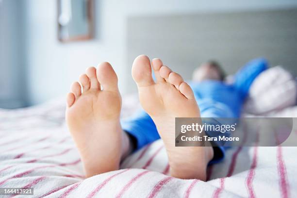 feet on bed - sole of foot stock pictures, royalty-free photos & images