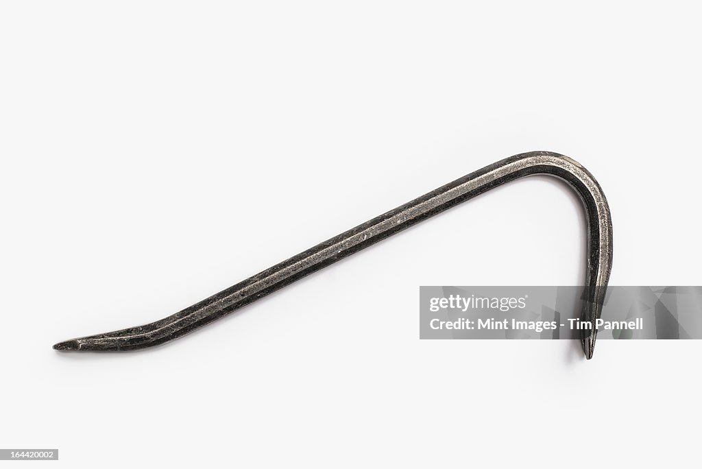 Used Tools. A crowbar, a metal objects with two curved ends. A tool for levering.
