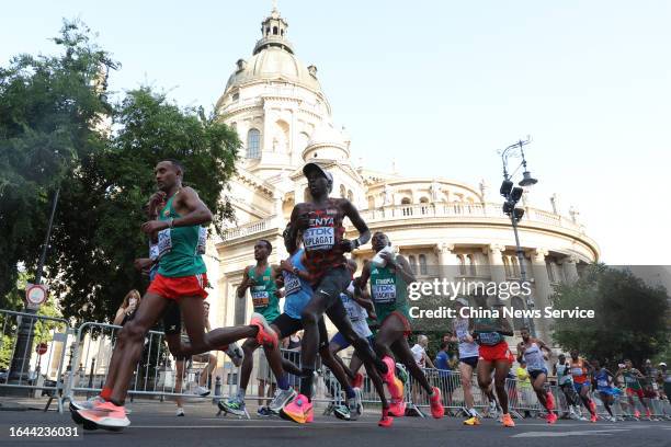 Leul Gebresilase of Team Ethiopia, Tamirat Tola of Team Ethiopia, Timothy Kiplagat of Team Kenya, Tsegaye Getachew of Team Ethiopia run past the St....