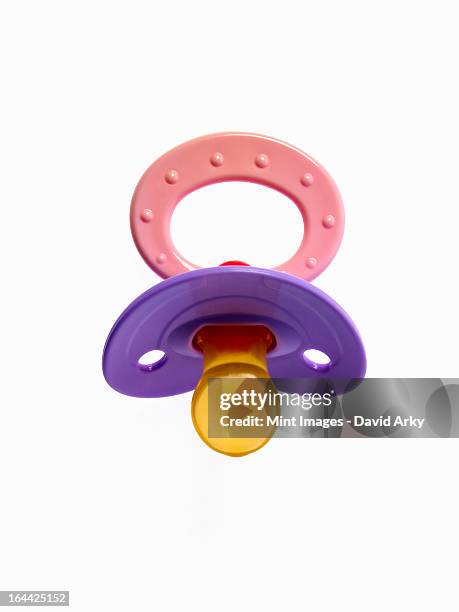 a coloured plastic baby pacifier, dummy or soother. - pacifier - fotografias e filmes do acervo