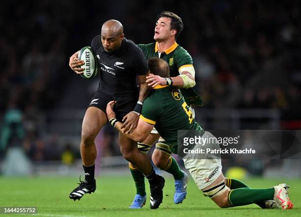 Mark Telea of New Zealand is double-tackled by Franco Mostert and Duane Vermeulen of South Africa during the Summer International match between New...