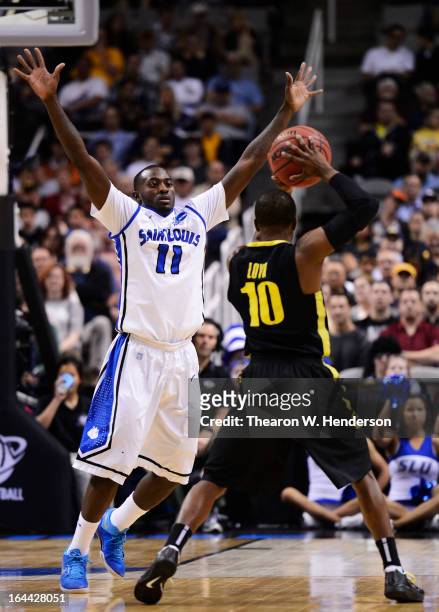 Mike McCall Jr. #11 of the Saint Louis Billikens guards Johnathan Loyd of the Oregon Ducks in the first half during the third round of the 2013 NCAA...