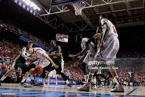 Stephan Van Treese of the Louisville Cardinals battles for a rebound with Wes Eikmeier and Greg Smith of the Colorado State Rams in the second half...