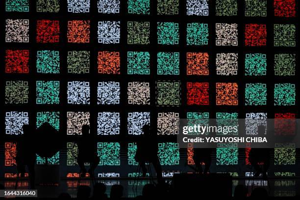 Codes are displayed on the stage as participants of the Indonesia's Championship Legacy Projects of ASEAN BAC sit on the stage for their...