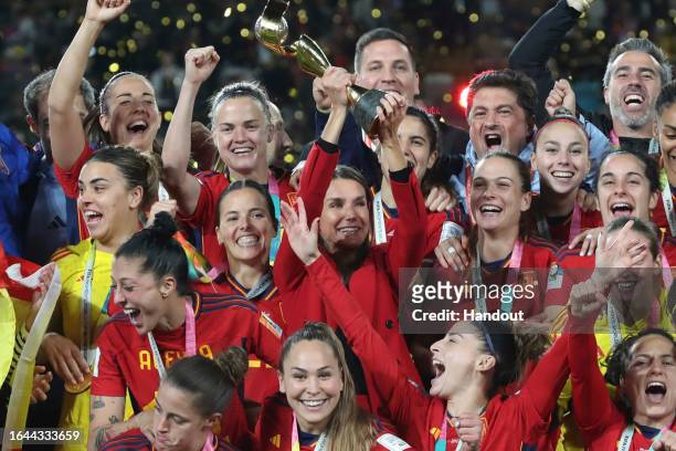 In this handout images released by the Spanish Royal Household, Queen Letizia of Spain is seen holding the trophy during the medal ceremony of FIFA...