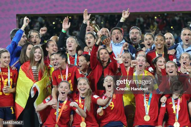 In this handout images released by the Spanish Royal Household, Queen Letizia of Spain is seen holding the trophy during the medal ceremony of FIFA...