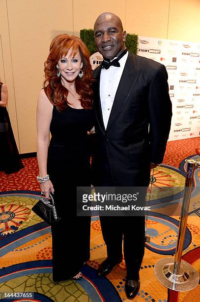 Singer Reba McEntire and Boxer Evander Holyfield with Moet & Chandon at Celebrity Fight Night XIX at JW Marriott Desert Ridge Resort & Spa on March...