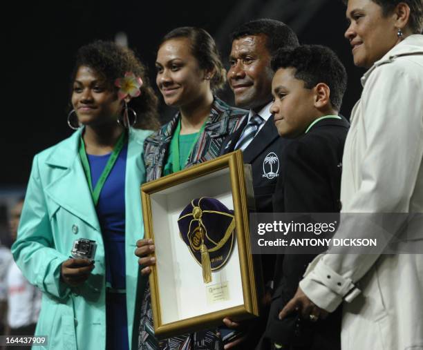 Fiji's Waisale Serevi stands with family members as he is inducted into the IRB Hall of Fame during the Hong Kong Rugby Sevens tournament on March...